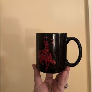 Vintage Marlboro Man black ceramic coffee mug with a red cowboy graphic